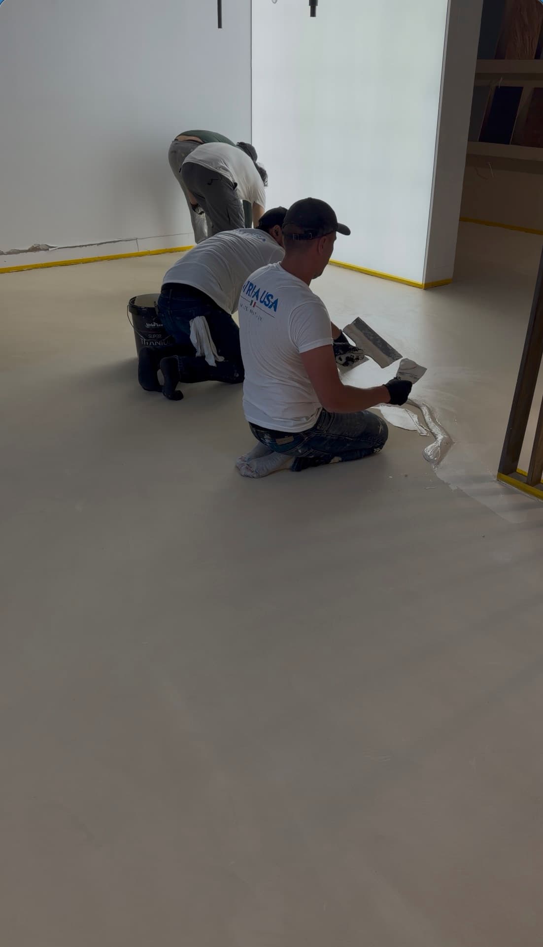 Dallas crew applying microcement, showroom detail