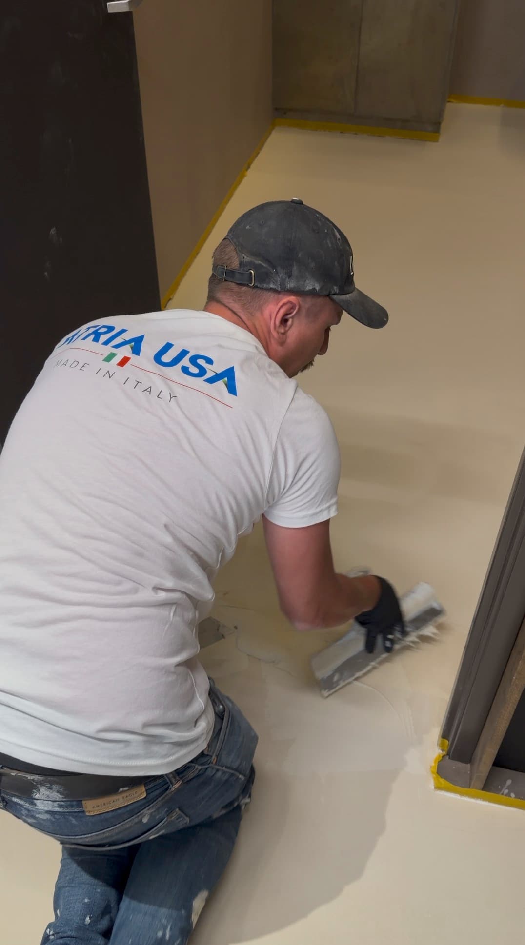 ATRIA USA branded shirt close-up during microcement application