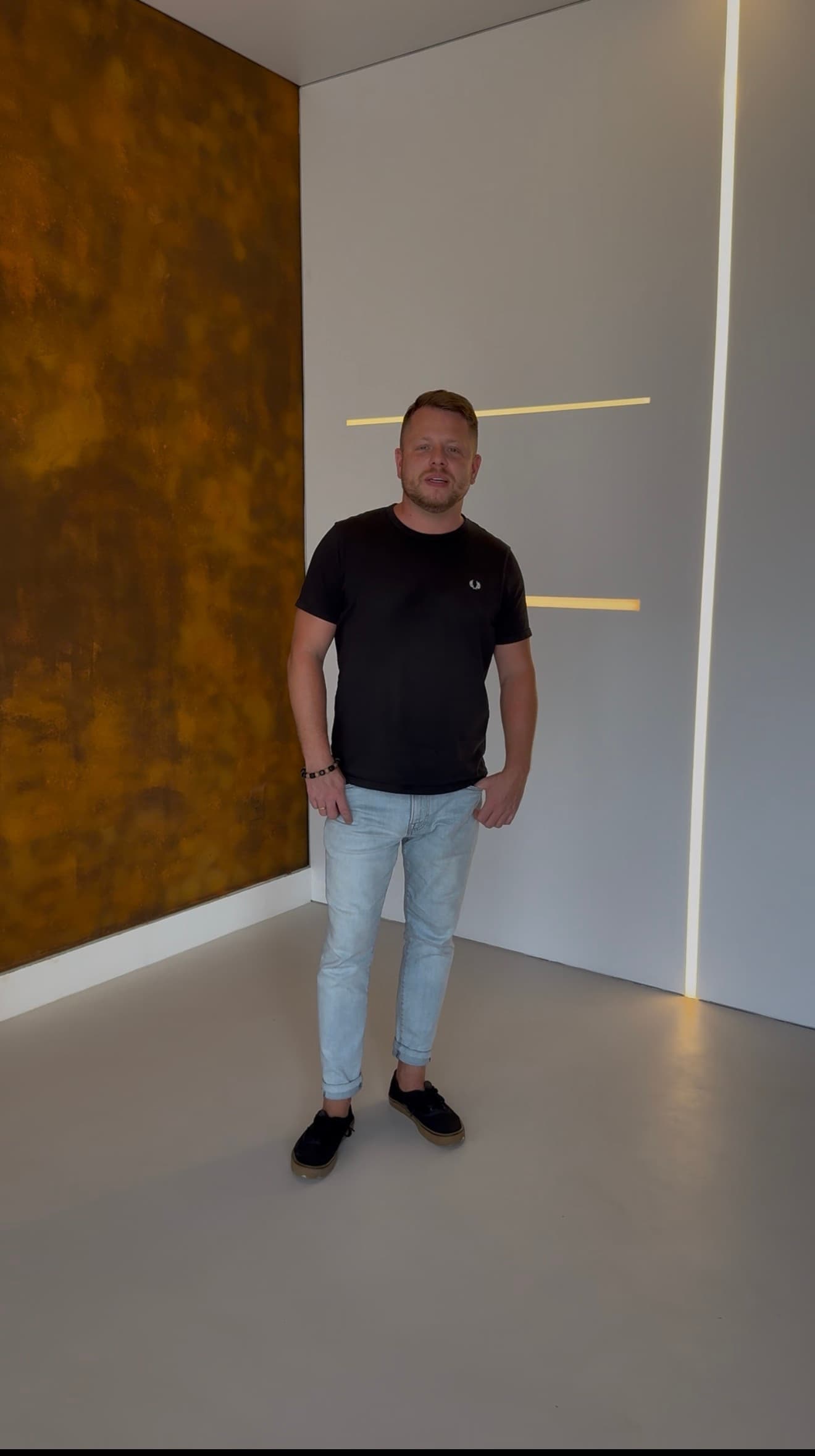 Tom standing in showroom with Wild Rust metallicum wall