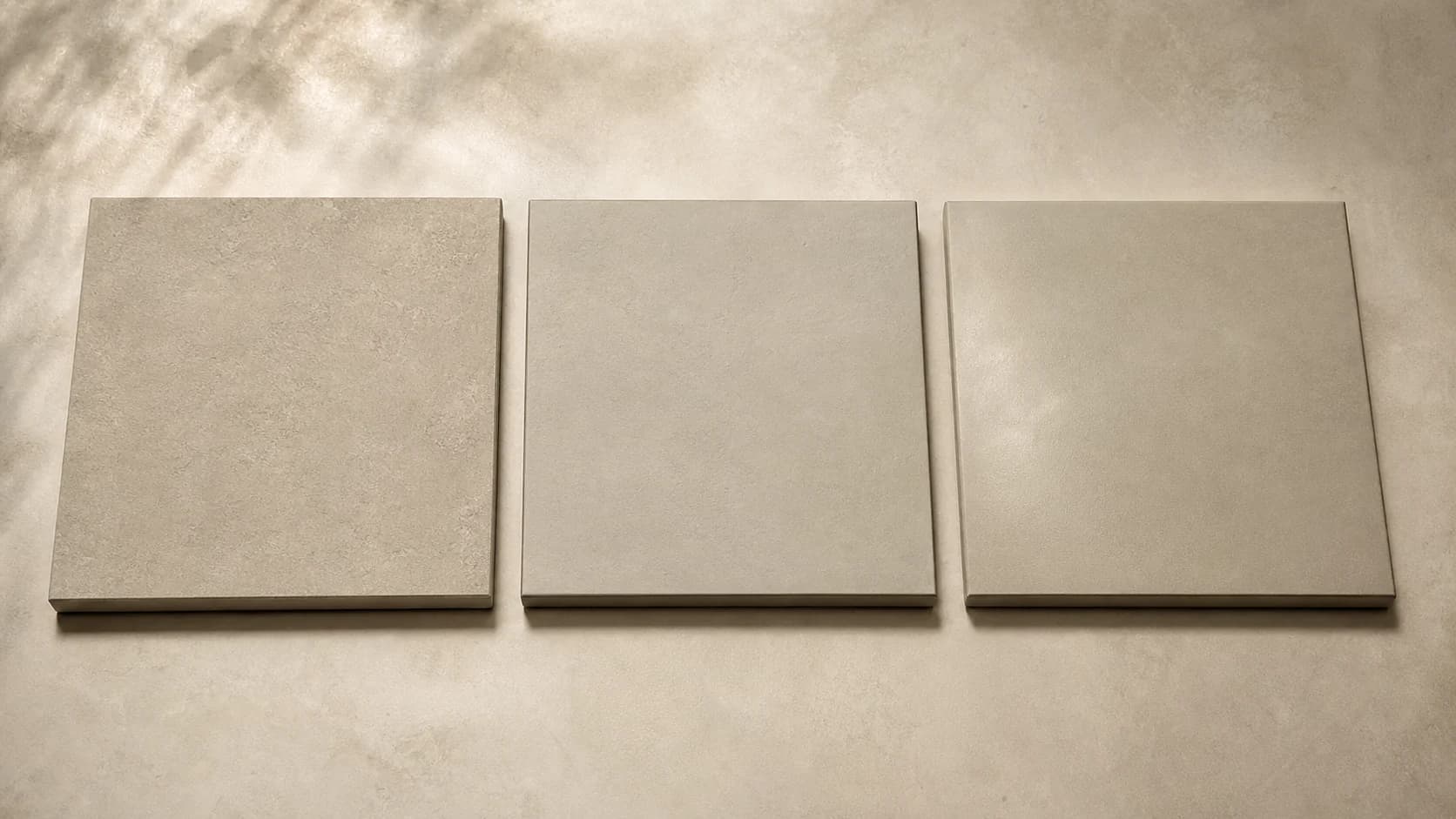 Three warm greige microcement swatches showing different surface refinements