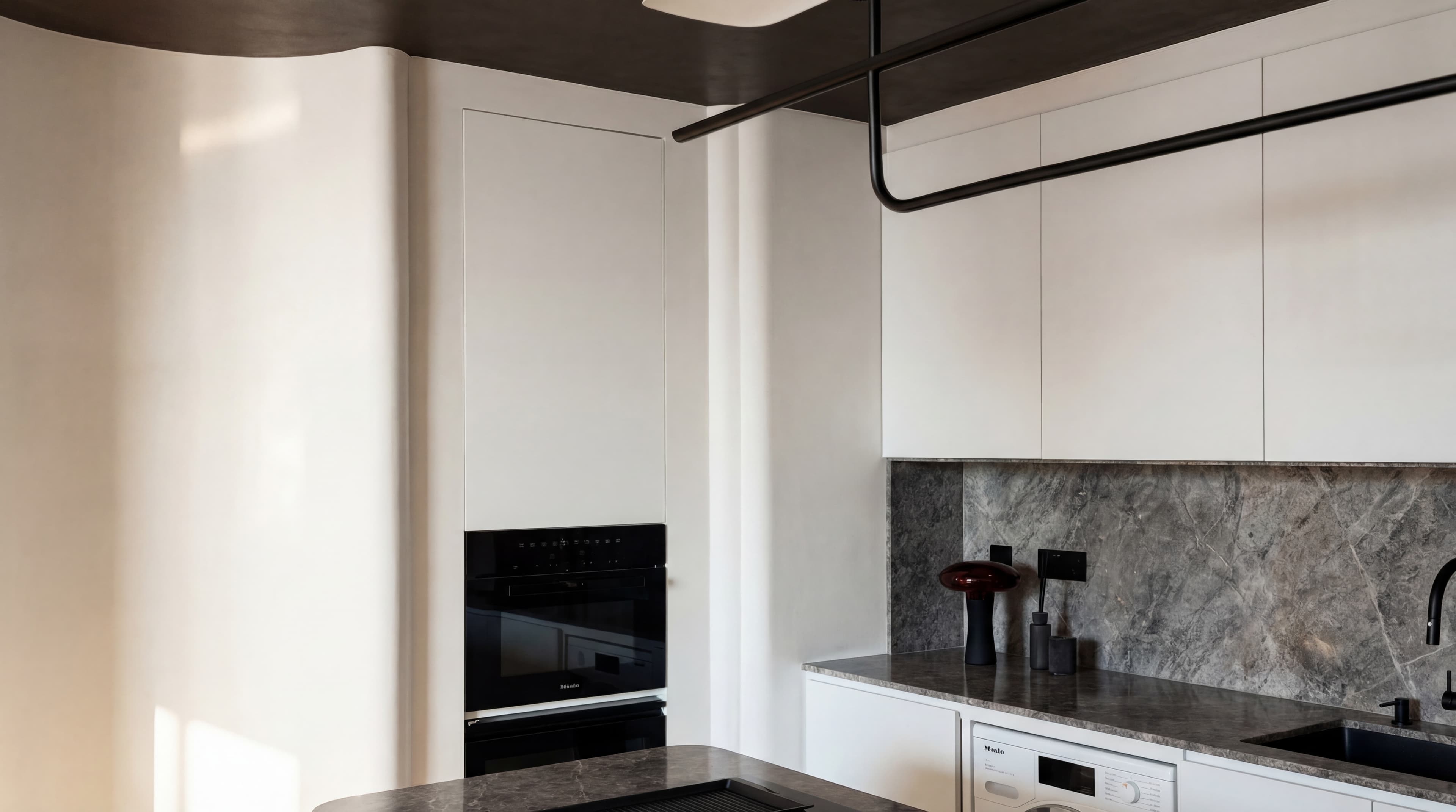 Grey Marble Kitchen — Dark countertop with black fixtures