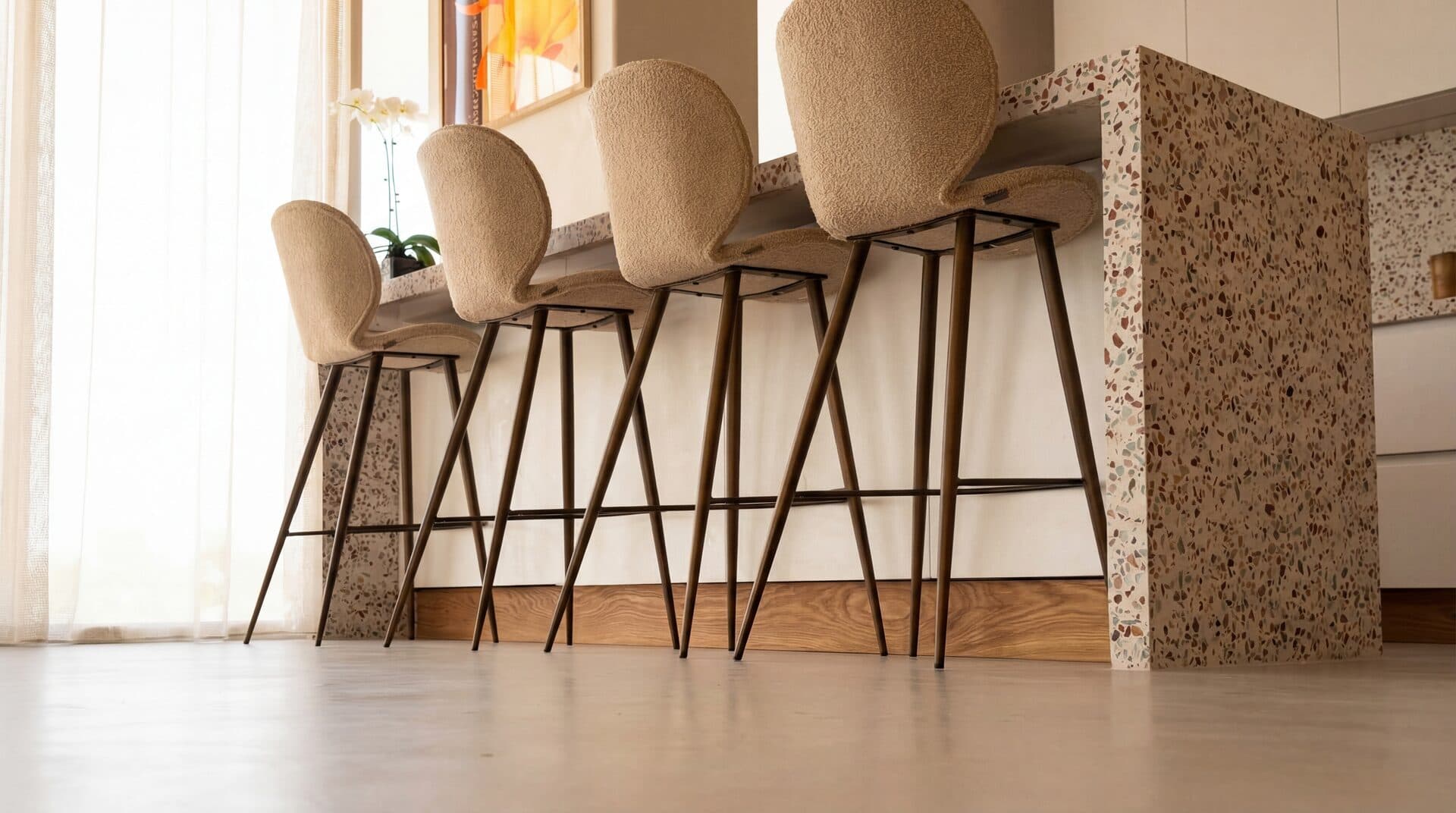 Terrazzo Counter — Boucle bar stools with terrazzo island