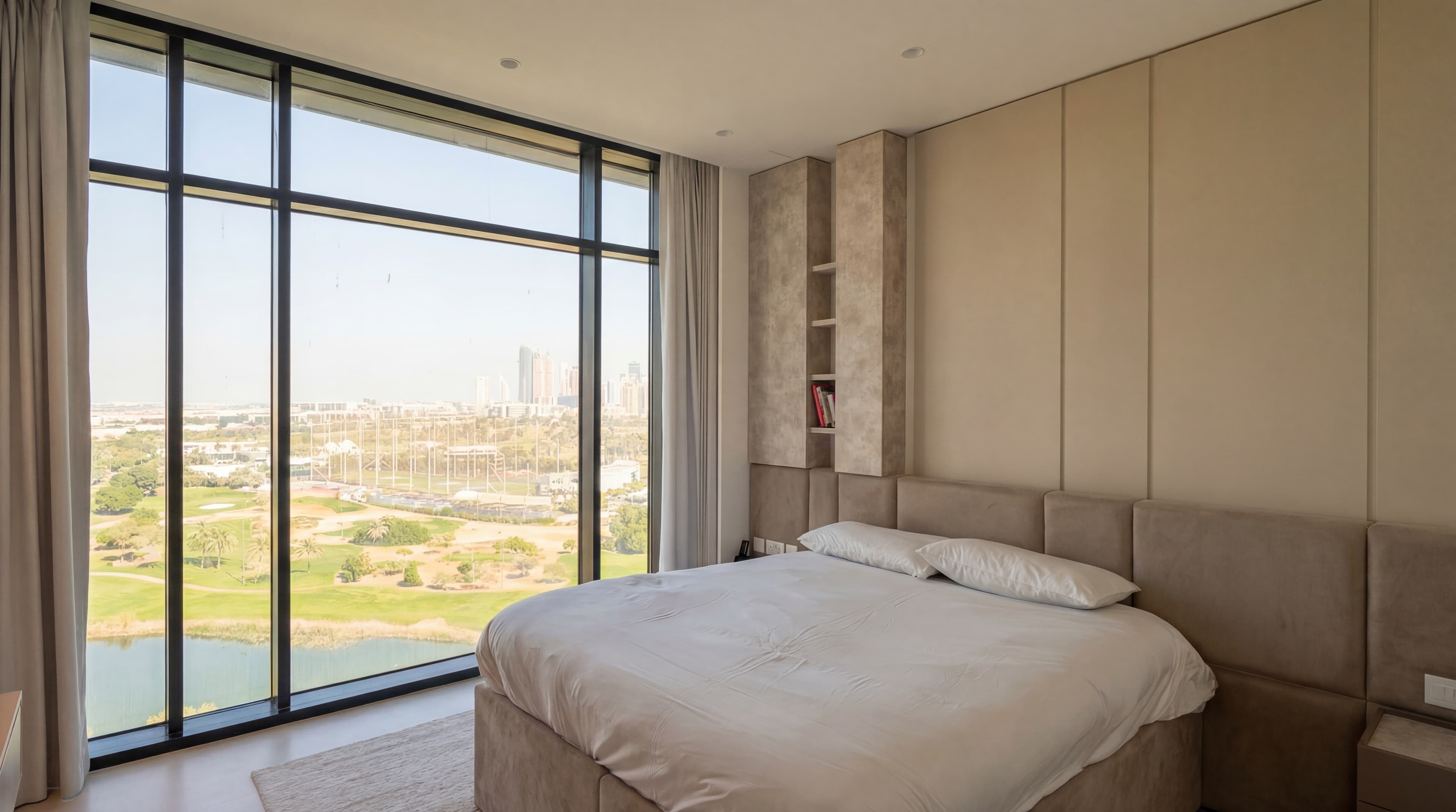 Skyline Bedroom — Floor-to-ceiling windows with golf views